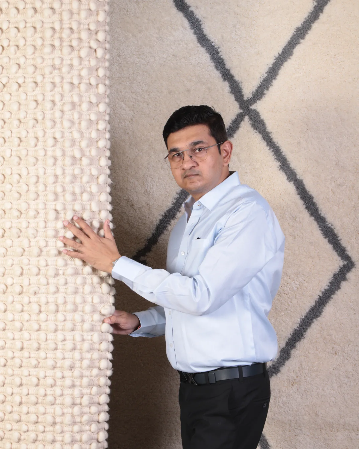 Amit N Jain inspecting a rug